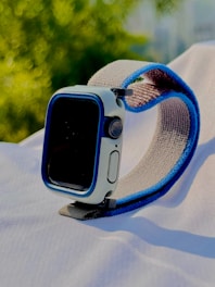 Close-up of sleek smartwatches and fitness trackers with light green accents reflecting the brand color.