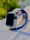 Close-up of a trendy smartwatch on a wrist with a modern tech setup in the background