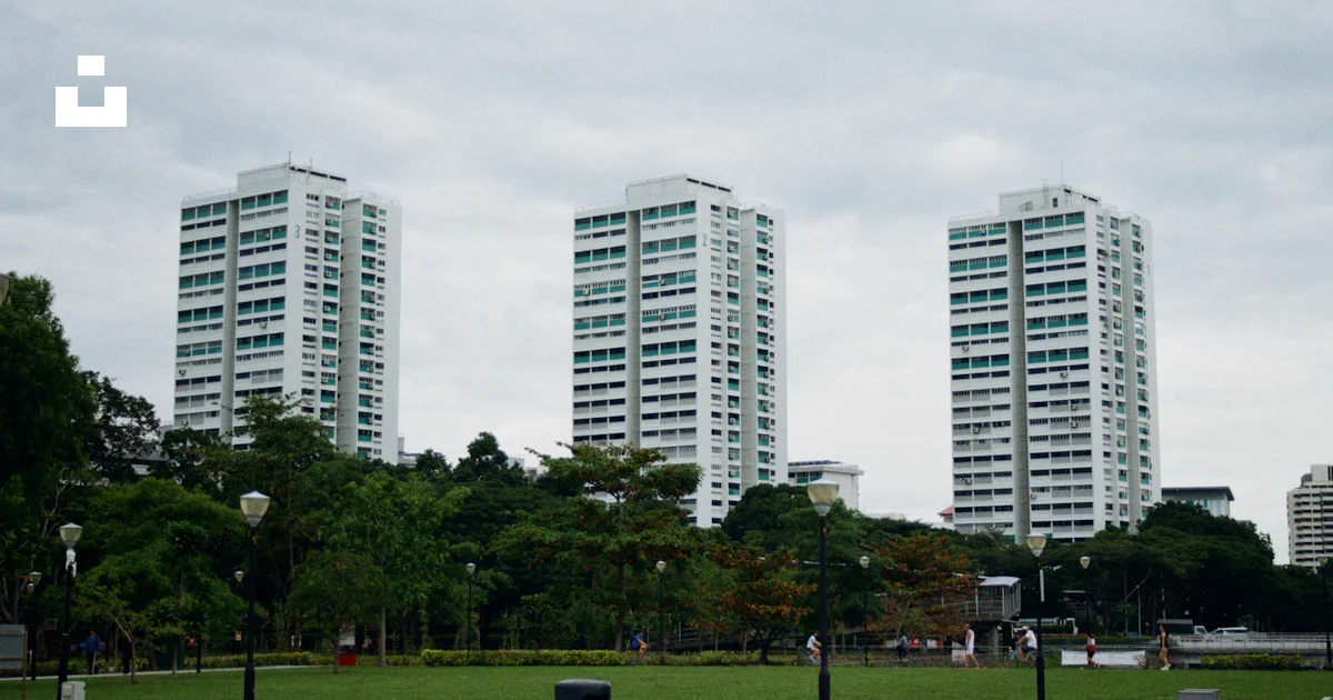 A couple of tall buildings sitting next to each other photo – Free ...