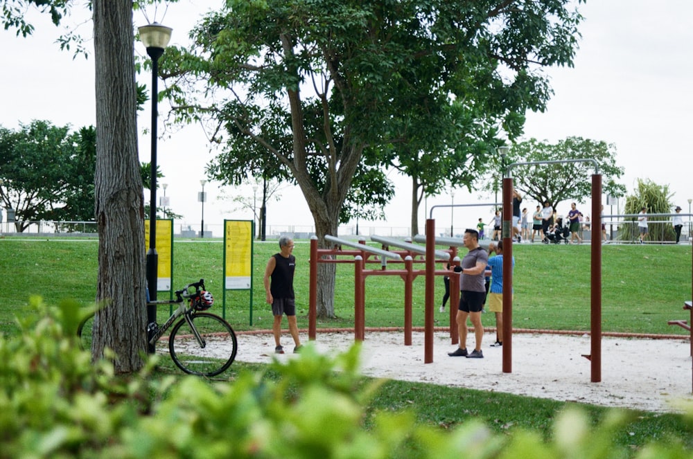 a group of people standing around a park