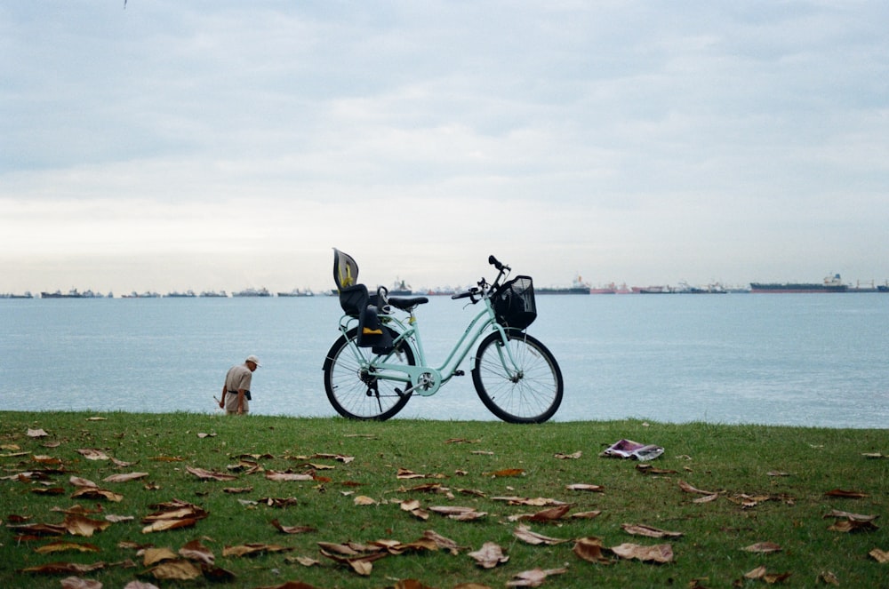 a bicycle parked next to a body of water