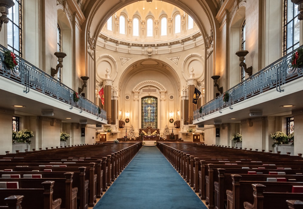 a church with a blue carpet and pews