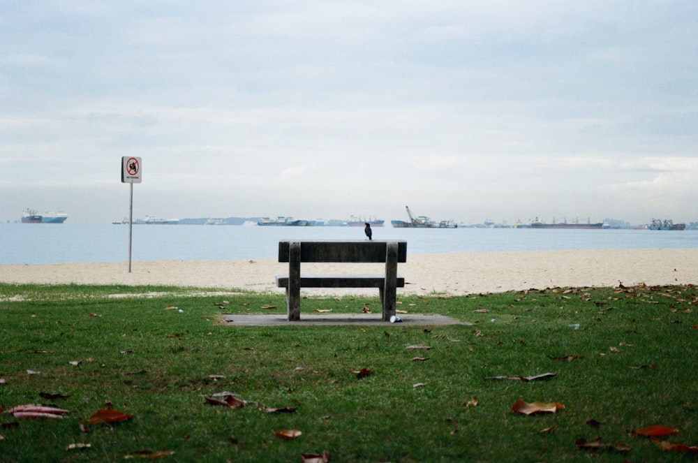 a bench sitting on top of a lush green field