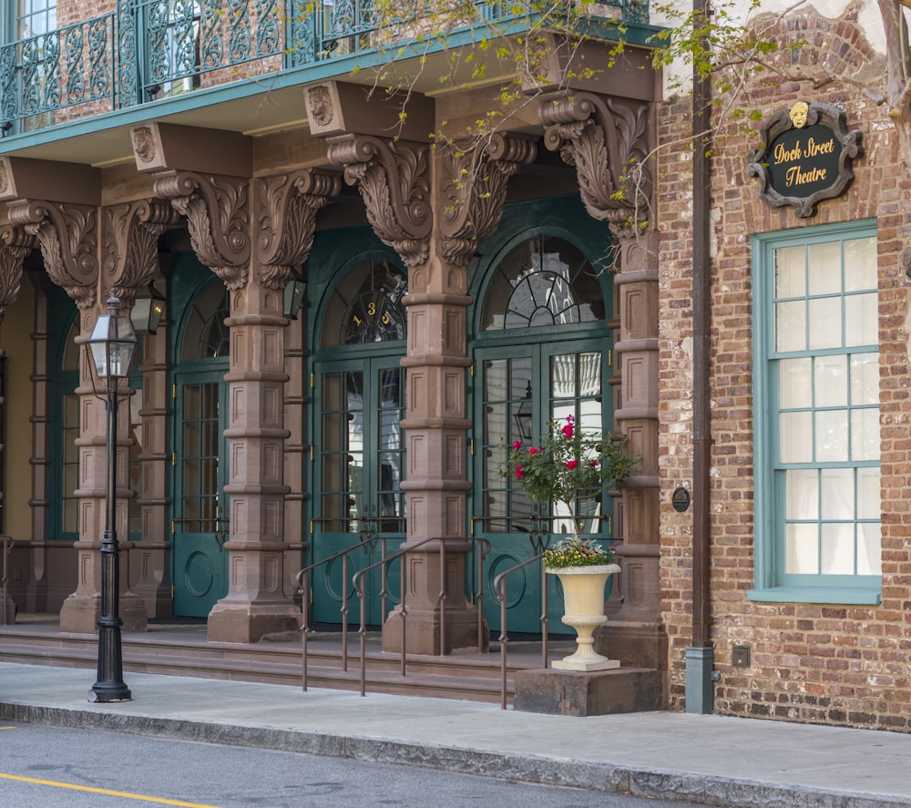 a tall building with a green door and balcony