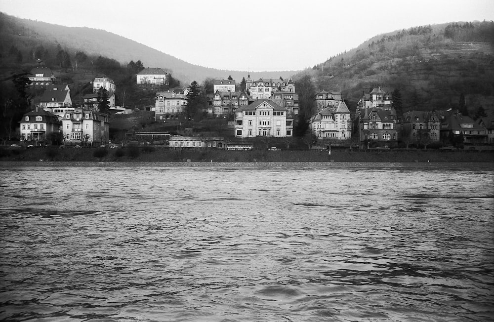a black and white photo of a town by the water