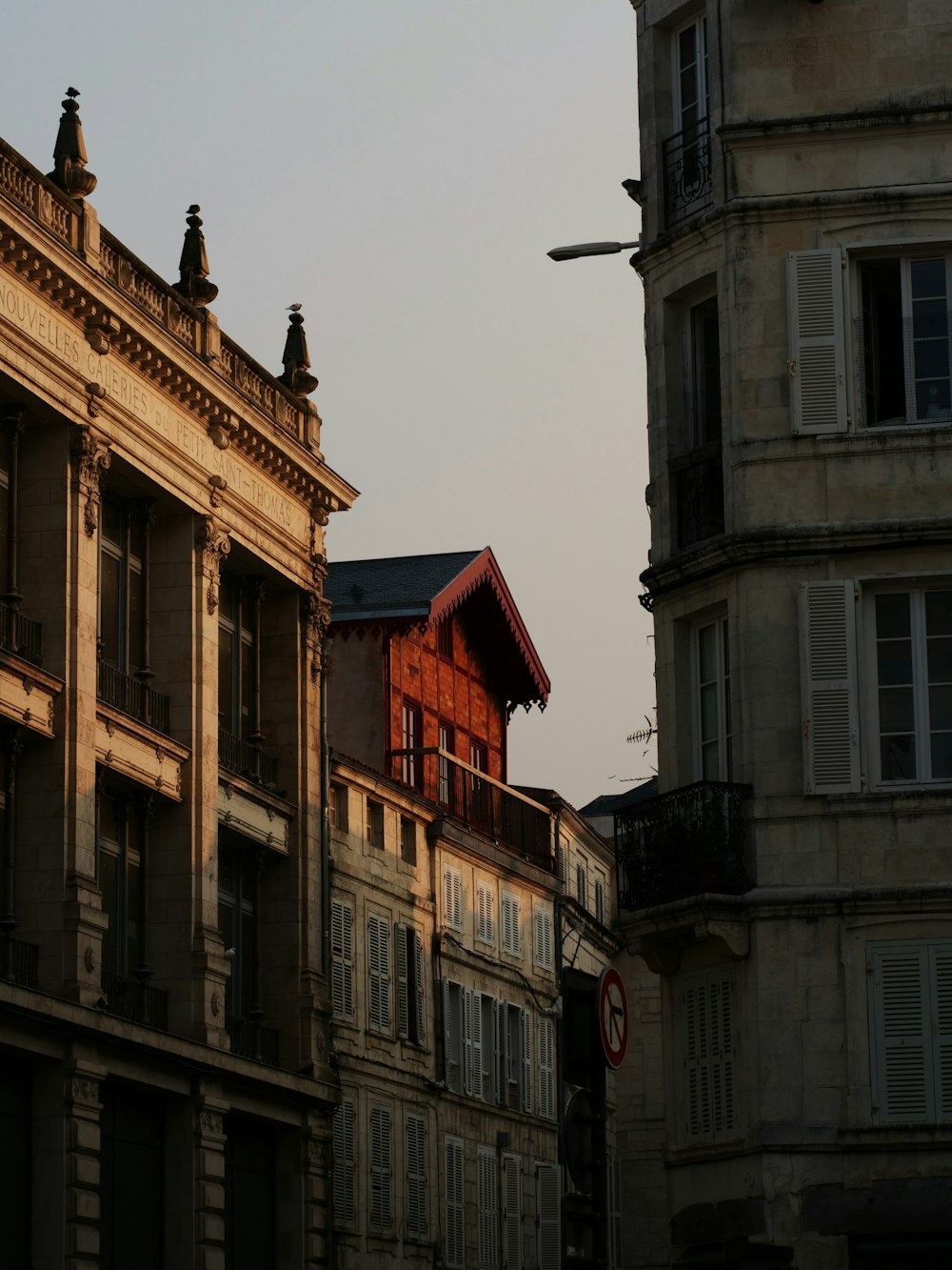 a building with a red roof next to other buildings