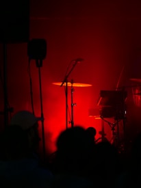 a band playing on a stage with red lighting