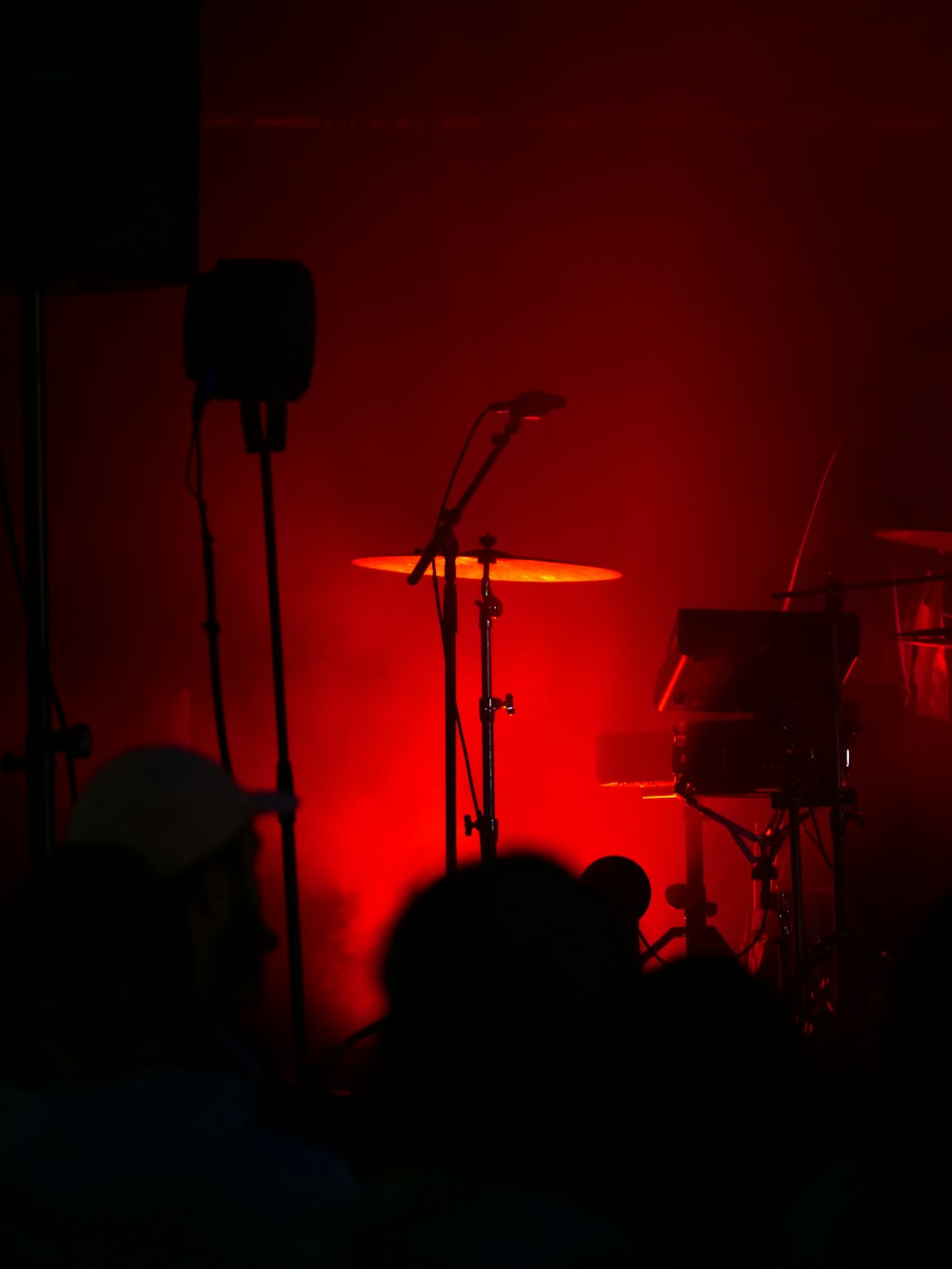 a band playing on a stage with red lighting