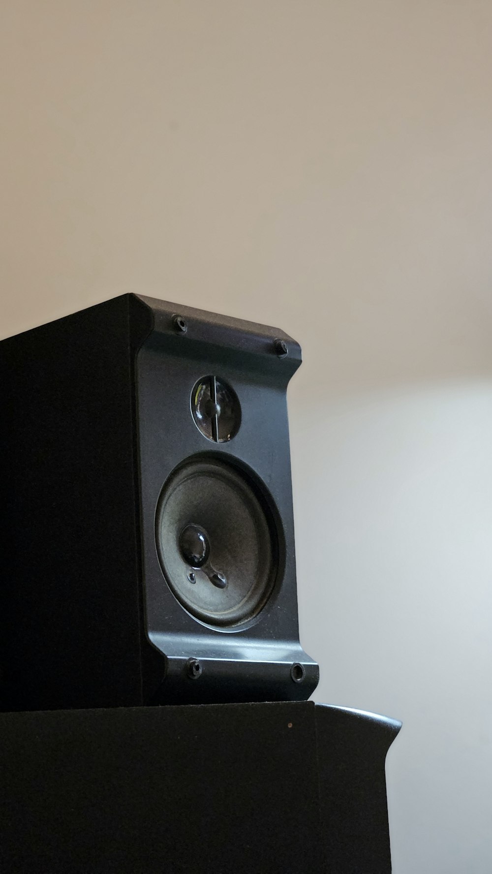 a black speaker sitting on top of a table