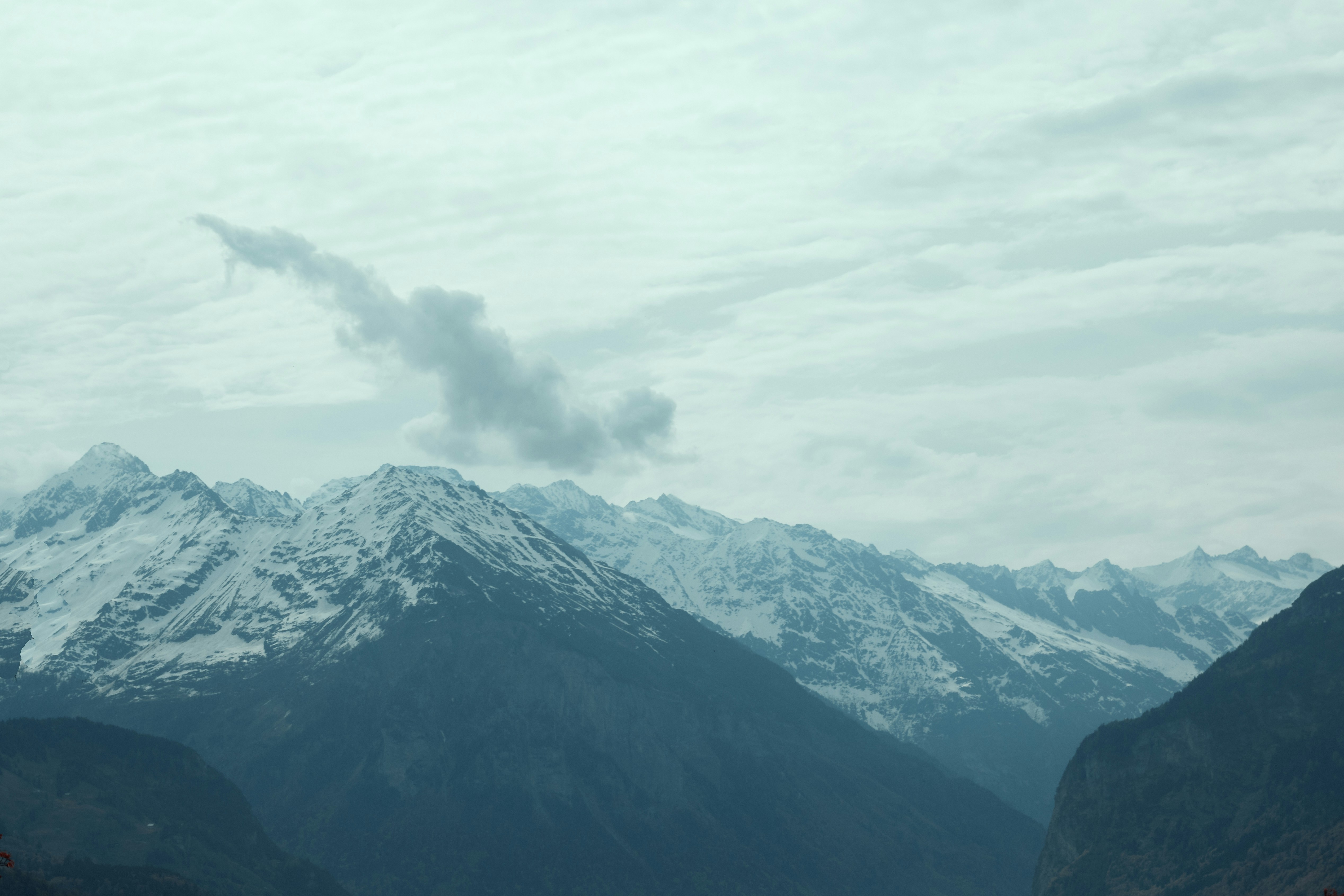 A view of a mountain range with a cloud in the sky photo – Free ...