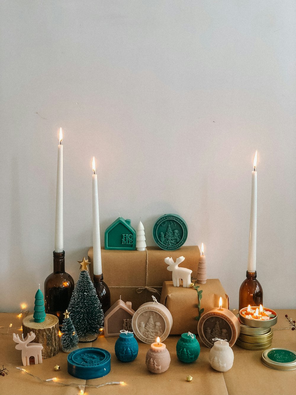 a table topped with candles and ornaments on top of a table