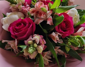 A vibrant mix of roses and peonies creating a romantic backdrop at a bridal shower.