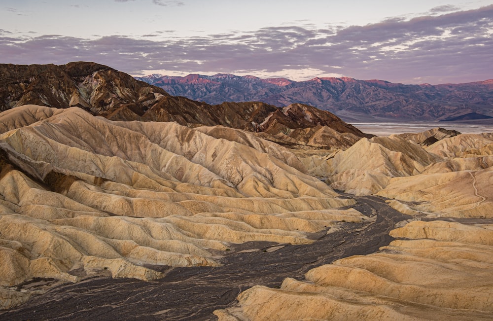 a river running through a valley surrounded by mountains