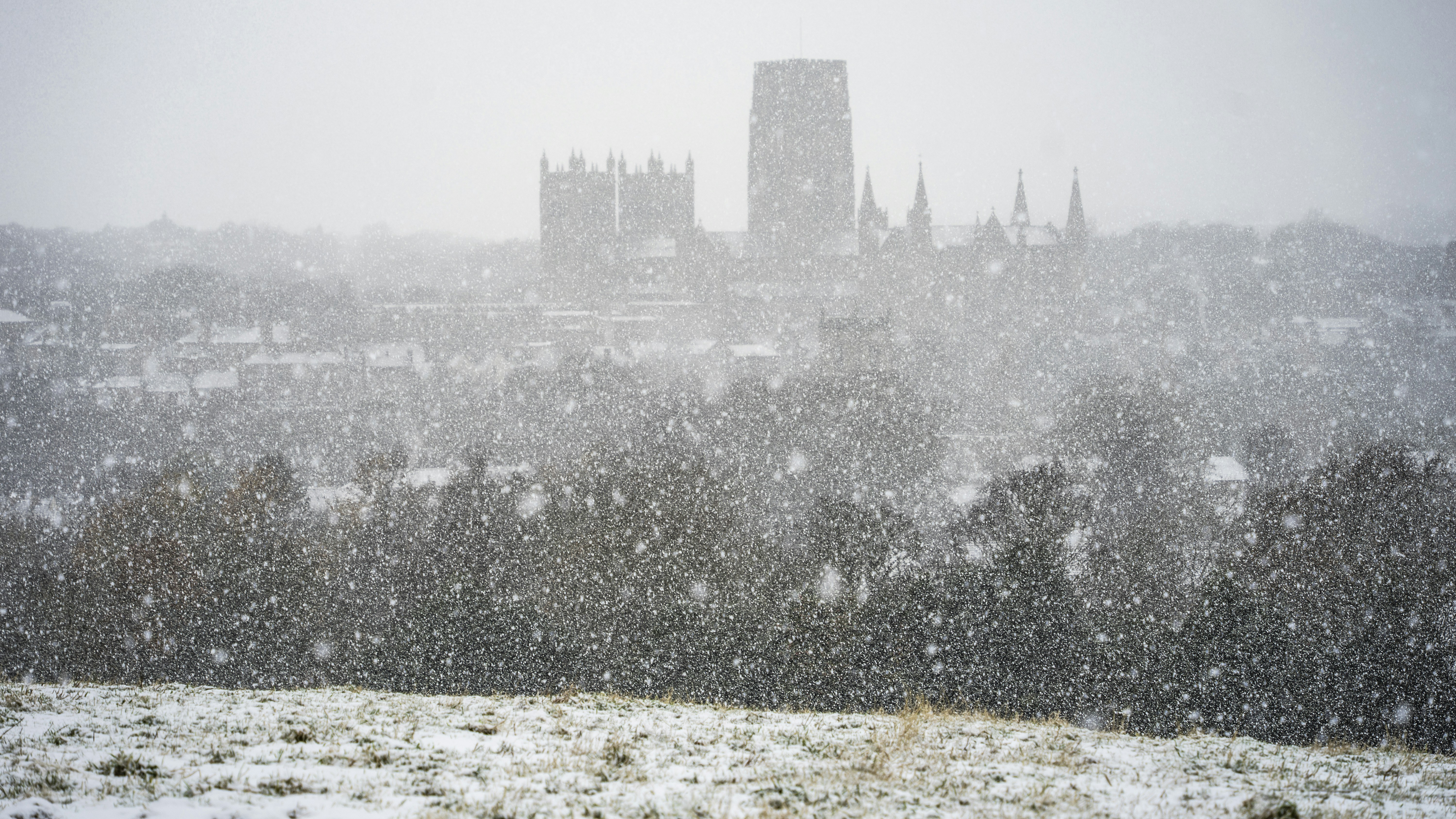 a snowy view of a city with a clock tower