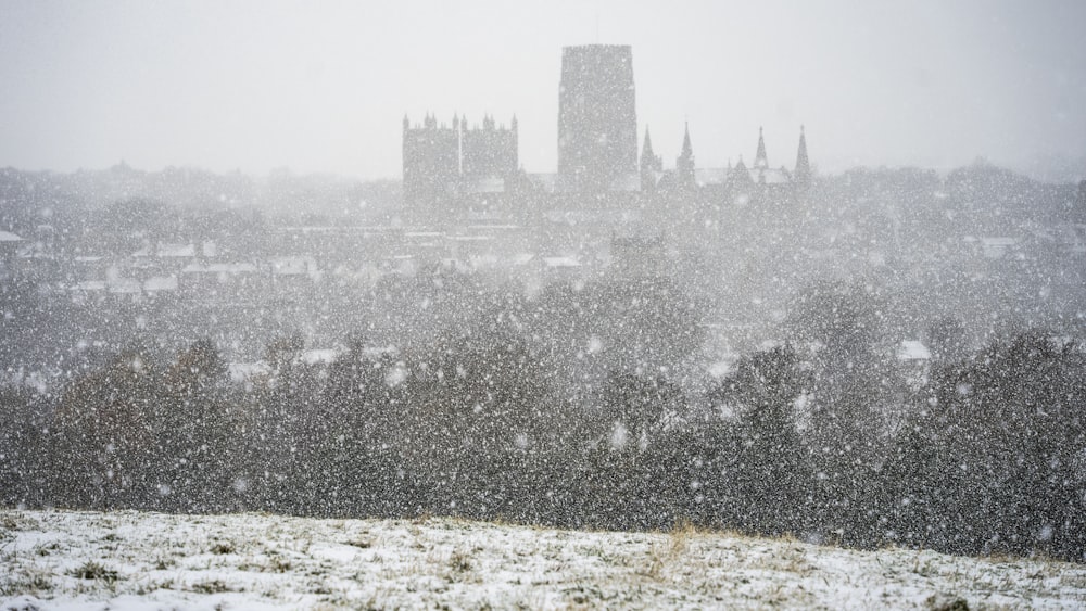 a snowy view of a city with a clock tower