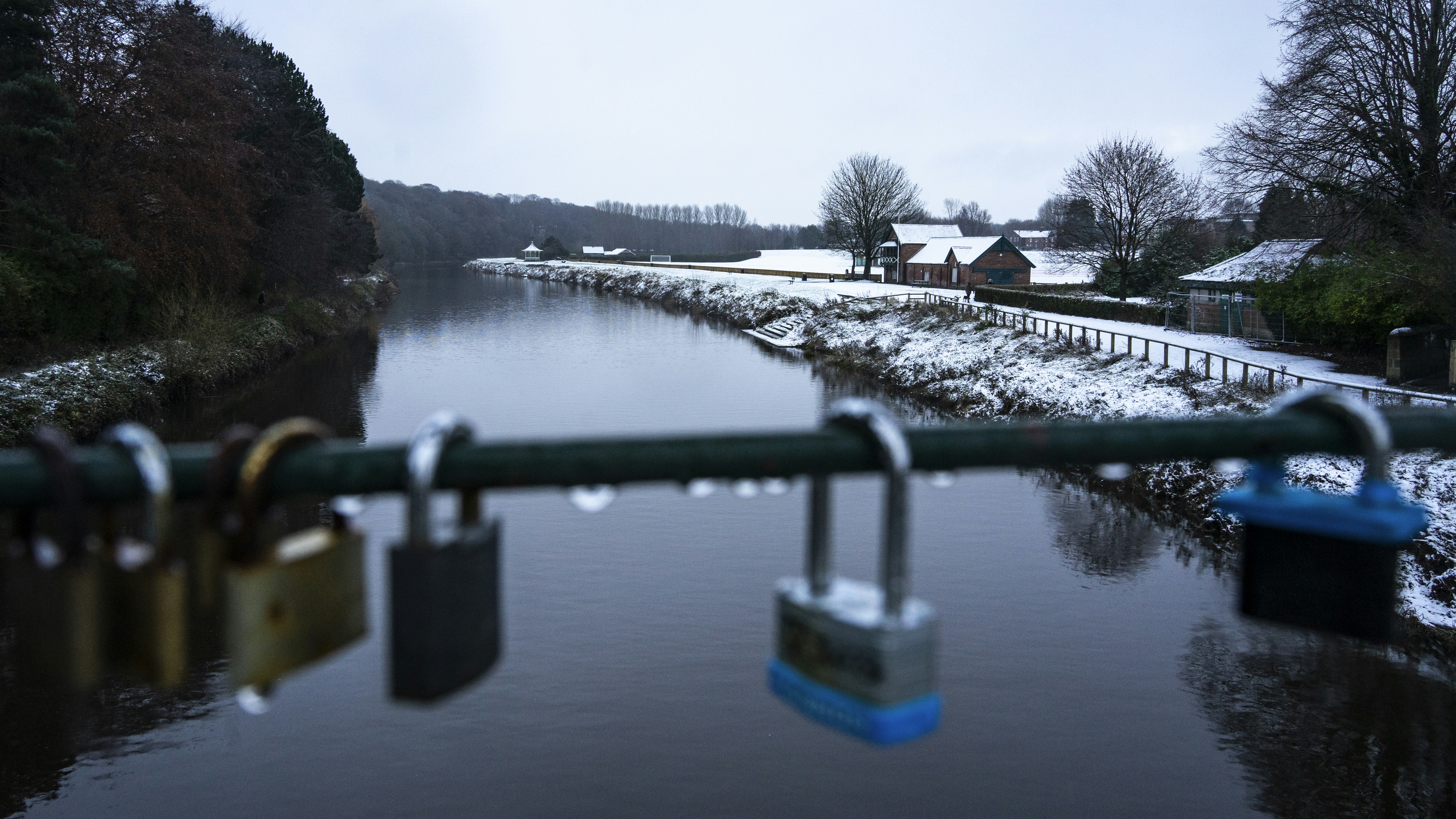 two padlocks on a bridge over a river