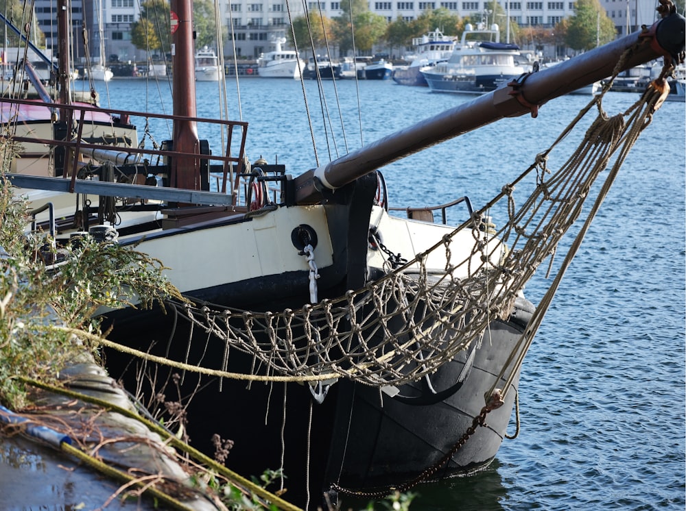 a boat docked in the water with a rope hanging off of it's side