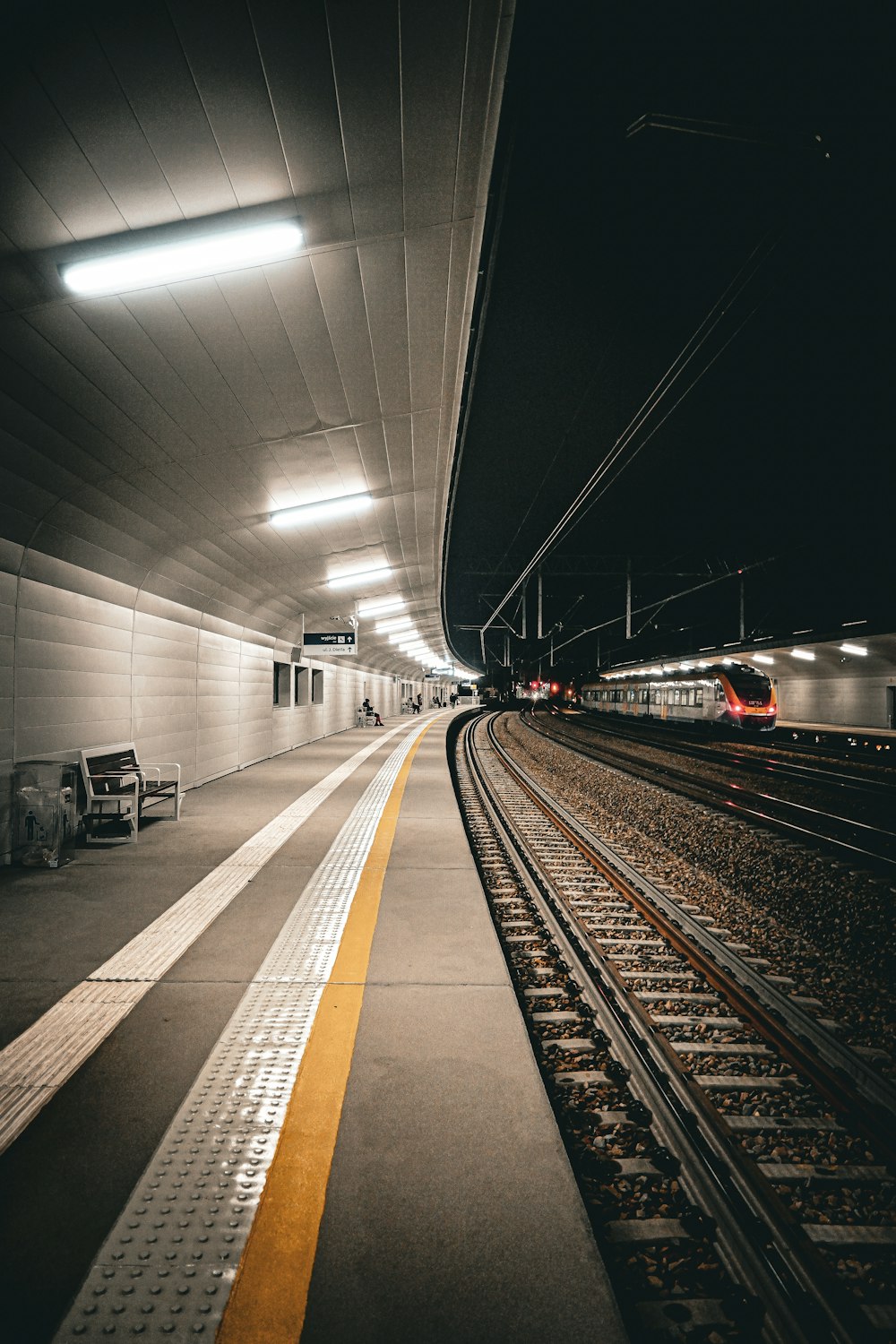 a train station with a train on the tracks