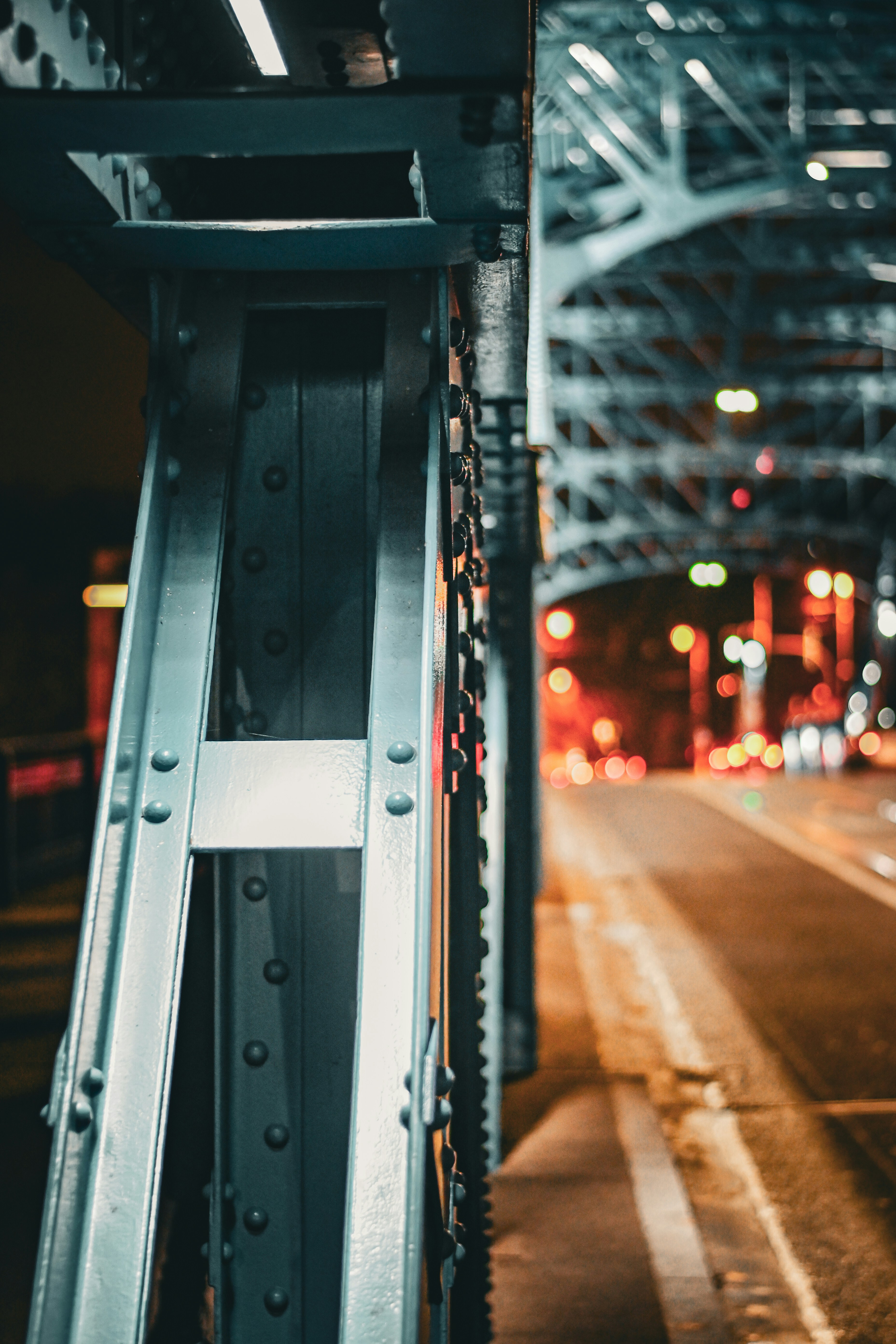 a view of a city street at night from under a bridge