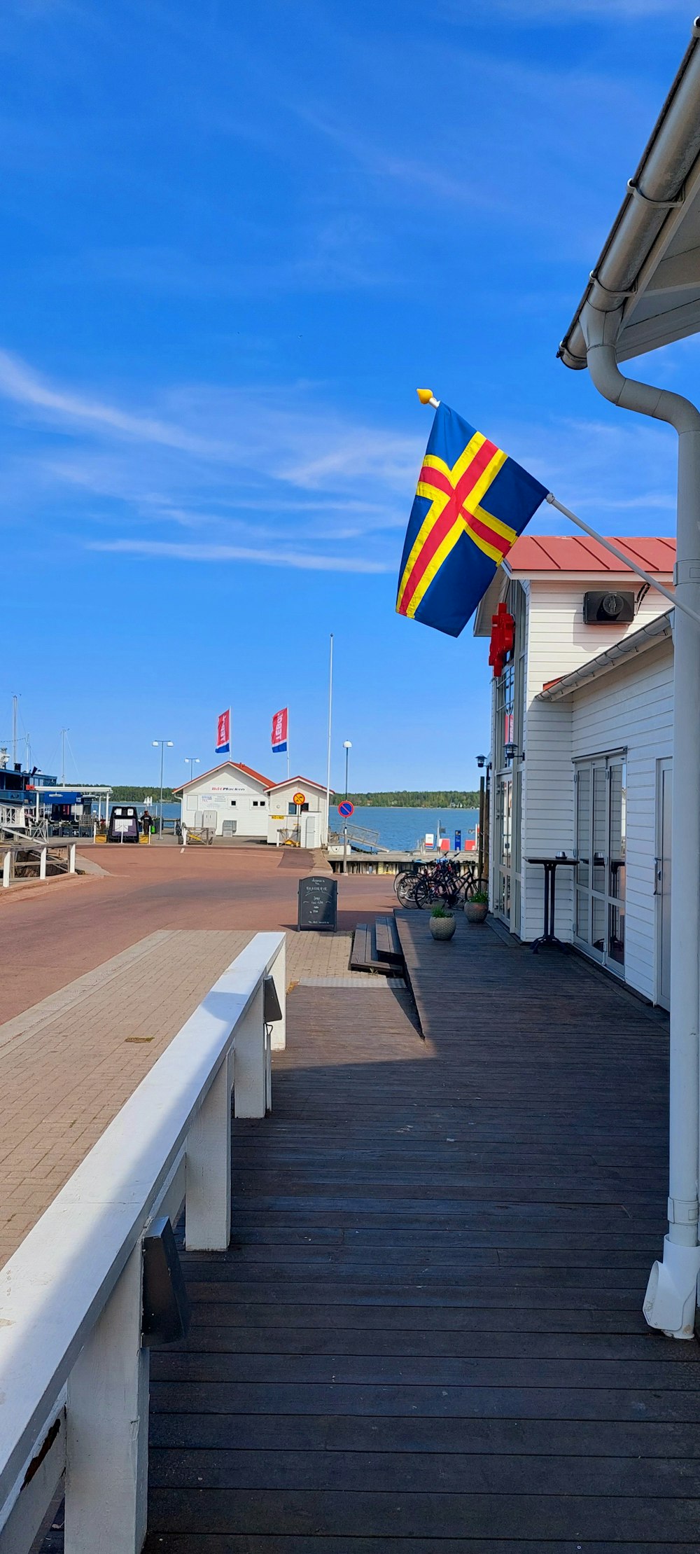 a flag on the side of a building on a boardwalk