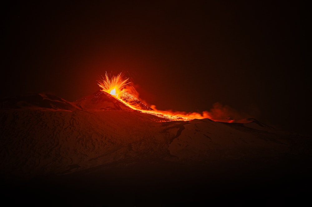 a bright orange and yellow fire on top of a mountain