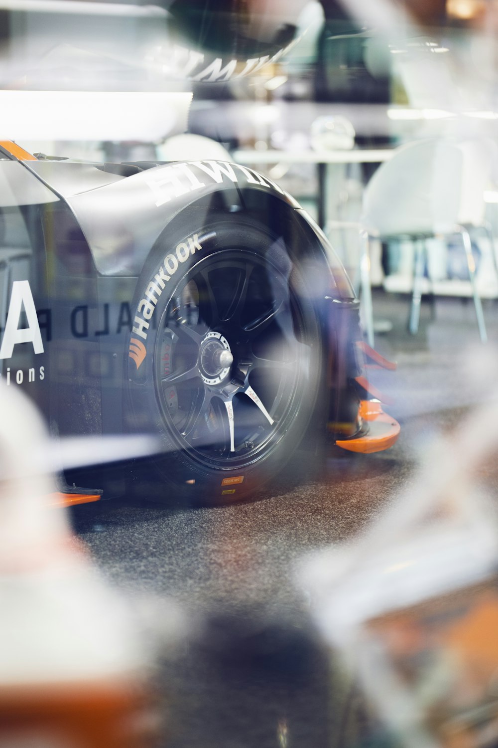 a close up of a racing car in a shop window
