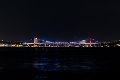 a bridge lit up at night over a body of water