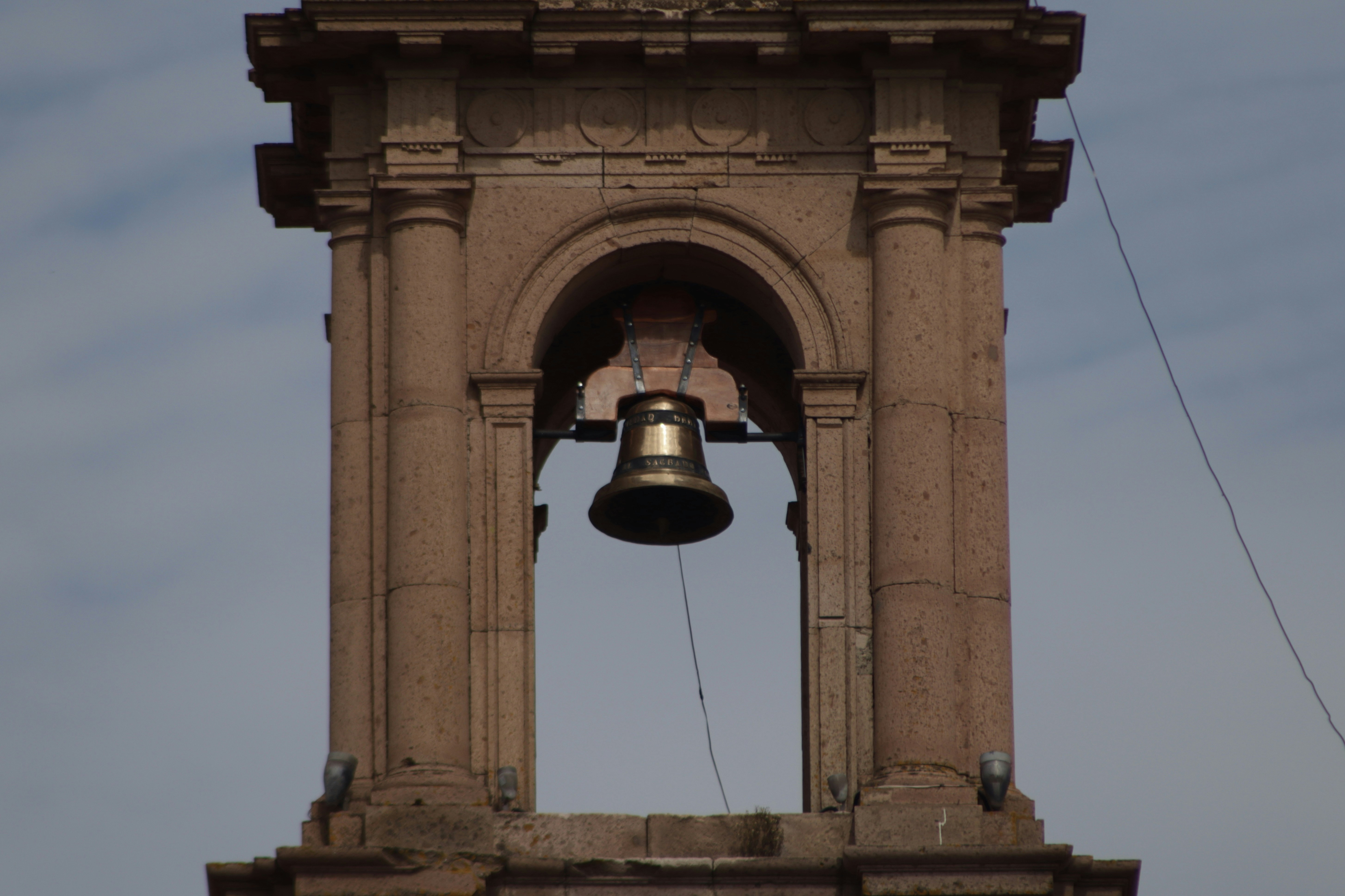 a bell tower with a bell on top of it