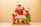A lively Santa laughing and playing with a group of excited children during Christmas.