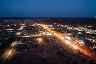 A close-up of energy-efficient LED streetlights illuminating a small town at dusk