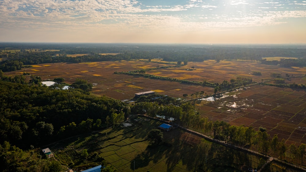 an aerial view of a large field with trees