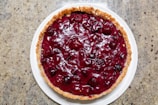 A vibrant cherry pie with bubbling filling, fresh out of the oven.