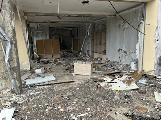 Photo showing a cluttered, worn-down room awaiting renovation.