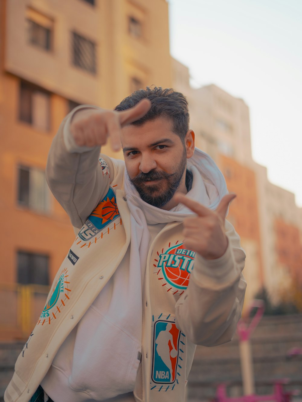 a man with a goatee pointing at the camera