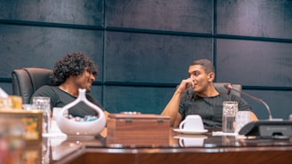 a couple of men sitting at a table