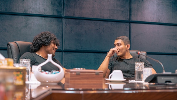 a couple of men sitting at a table