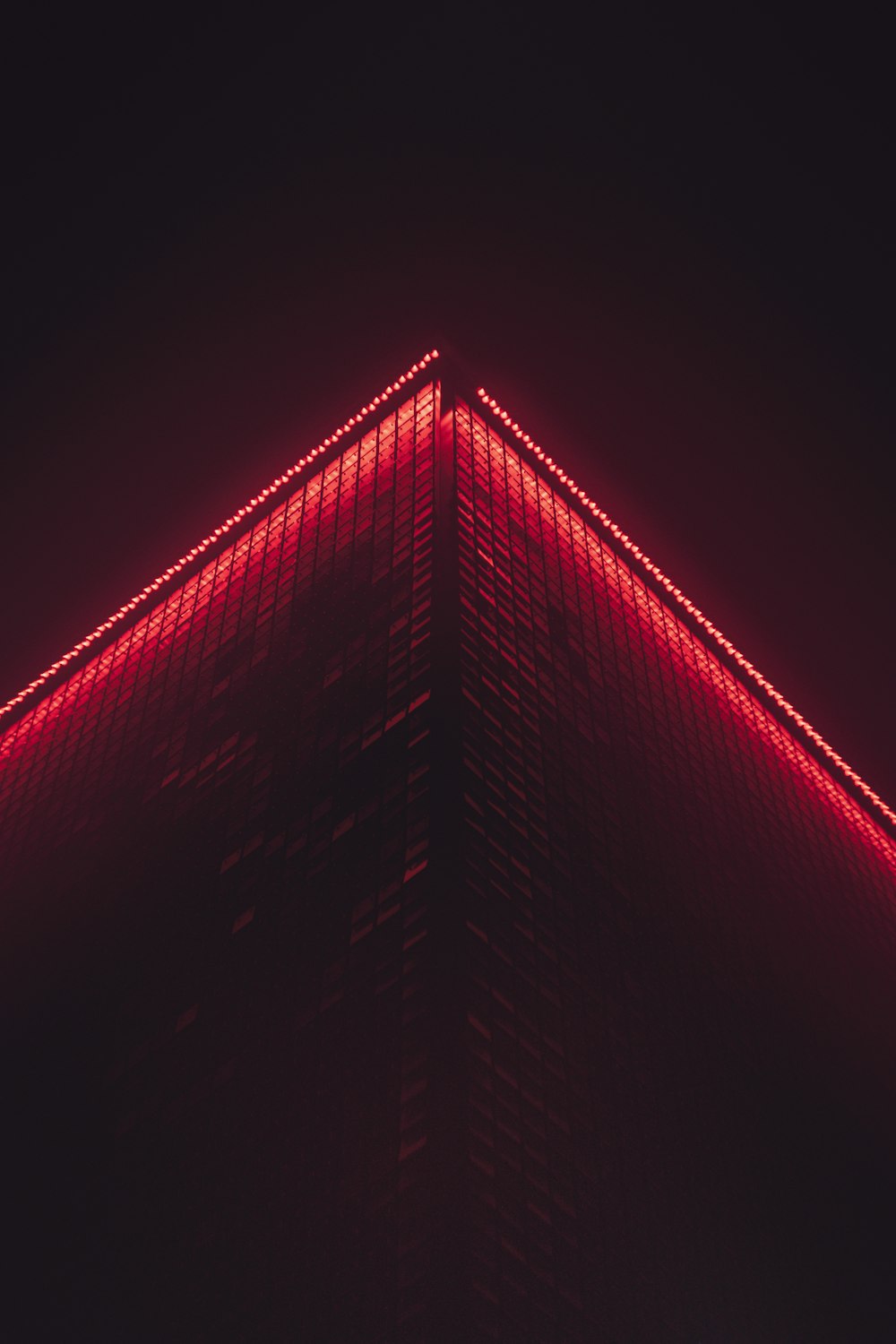 a very tall building with a red light on it's side