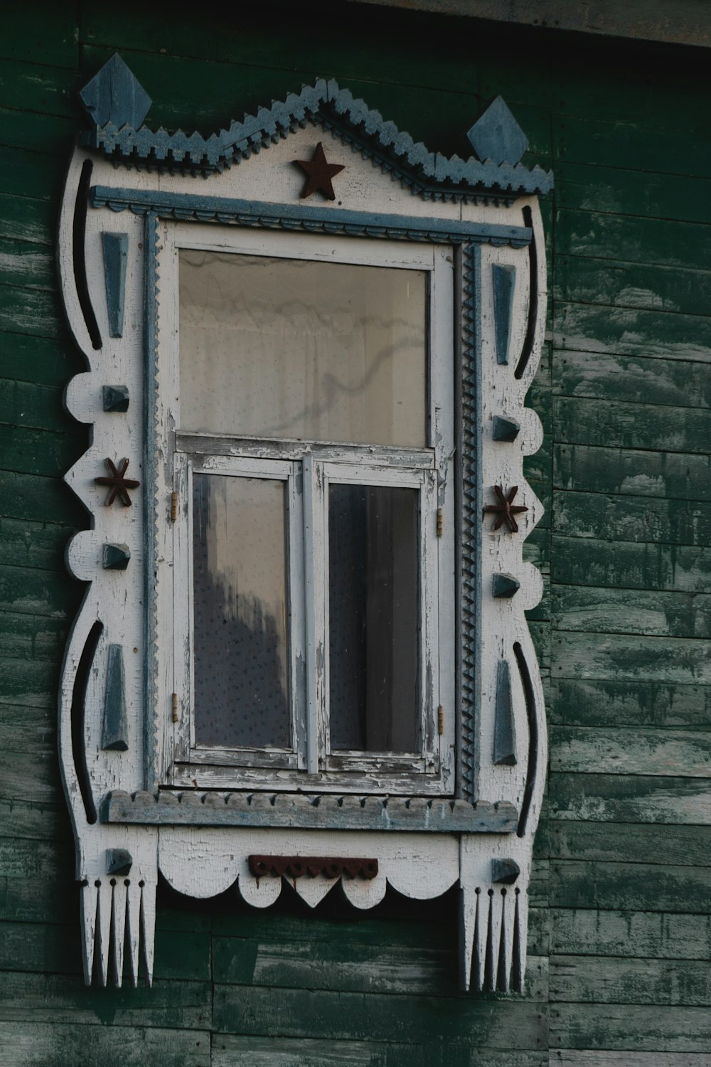 a window on a green building with stars on it