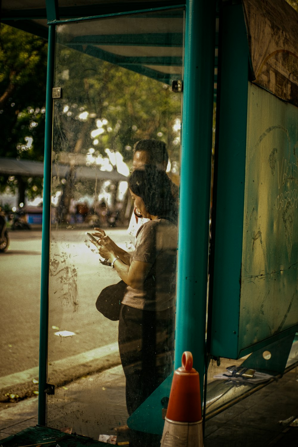 a man and a woman looking at their cell phones