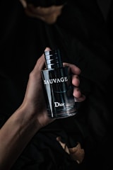 A sleek, modern men's cologne bottle with a dark, masculine background.