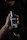 Close-up of a man spraying fragrance with a stylish, dark backdrop
