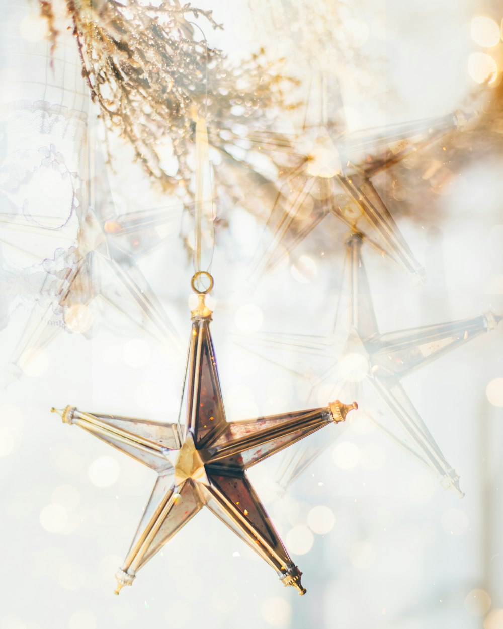a star ornament hanging from a tree