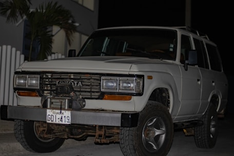 A sleek Toyota SUV parked outside the dealership with the Medellín skyline in the background.