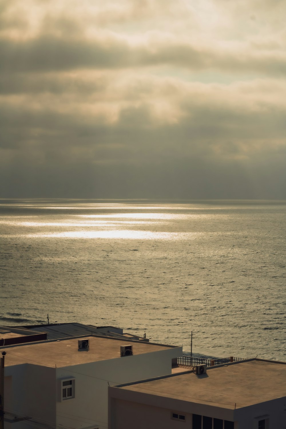 a view of the ocean from a rooftop of a building