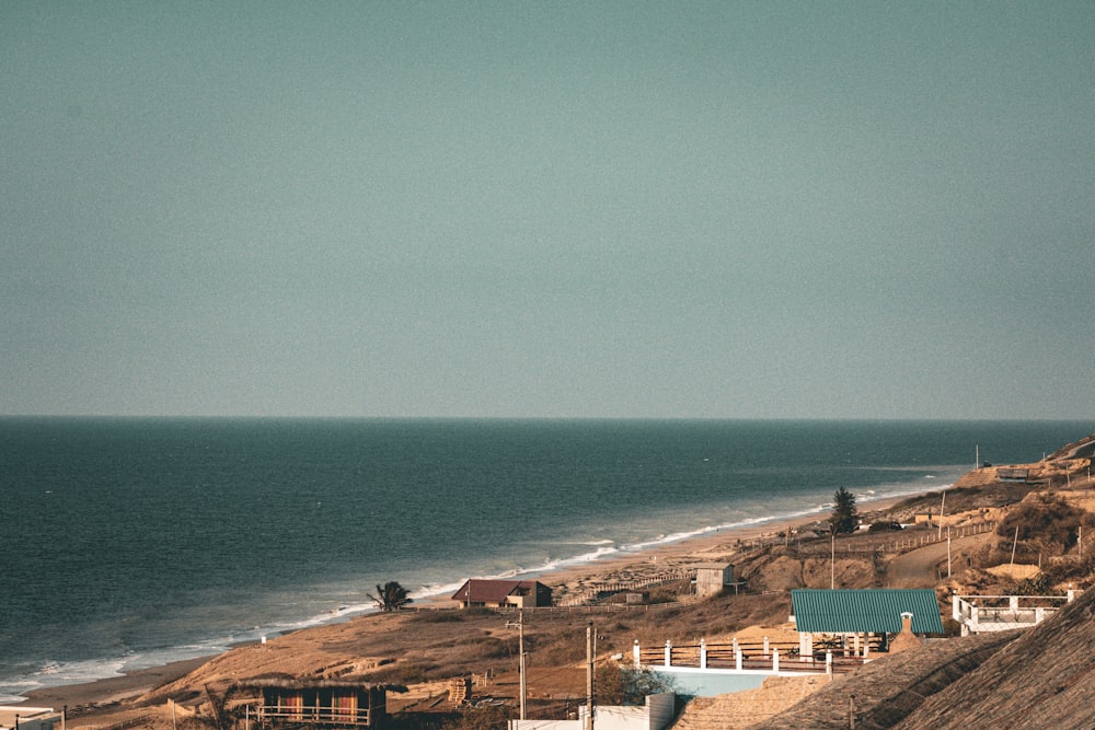 a large body of water sitting next to a sandy beach