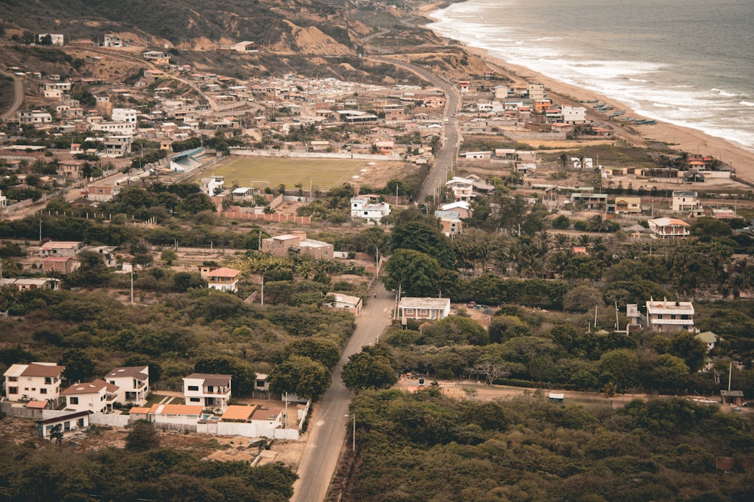 an aerial view of a small town by the ocean,