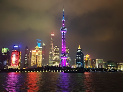A vibrant city skyline of Shanghai at twilight with glowing lights and modern skyscrapers
