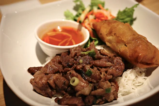 a white plate topped with meat and veggies