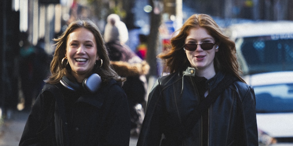 a couple of women walking down a street next to each other