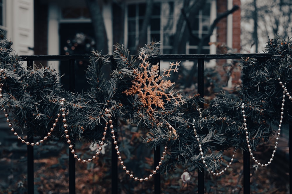 a snowflake is hanging on a fence